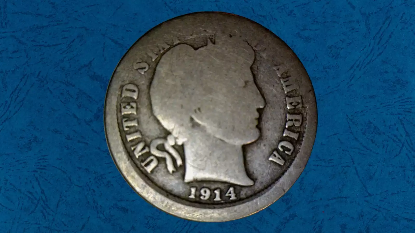 1914 Barber Half Dollar off-center strike error showing design displaced from center with visible blank planchet crescent